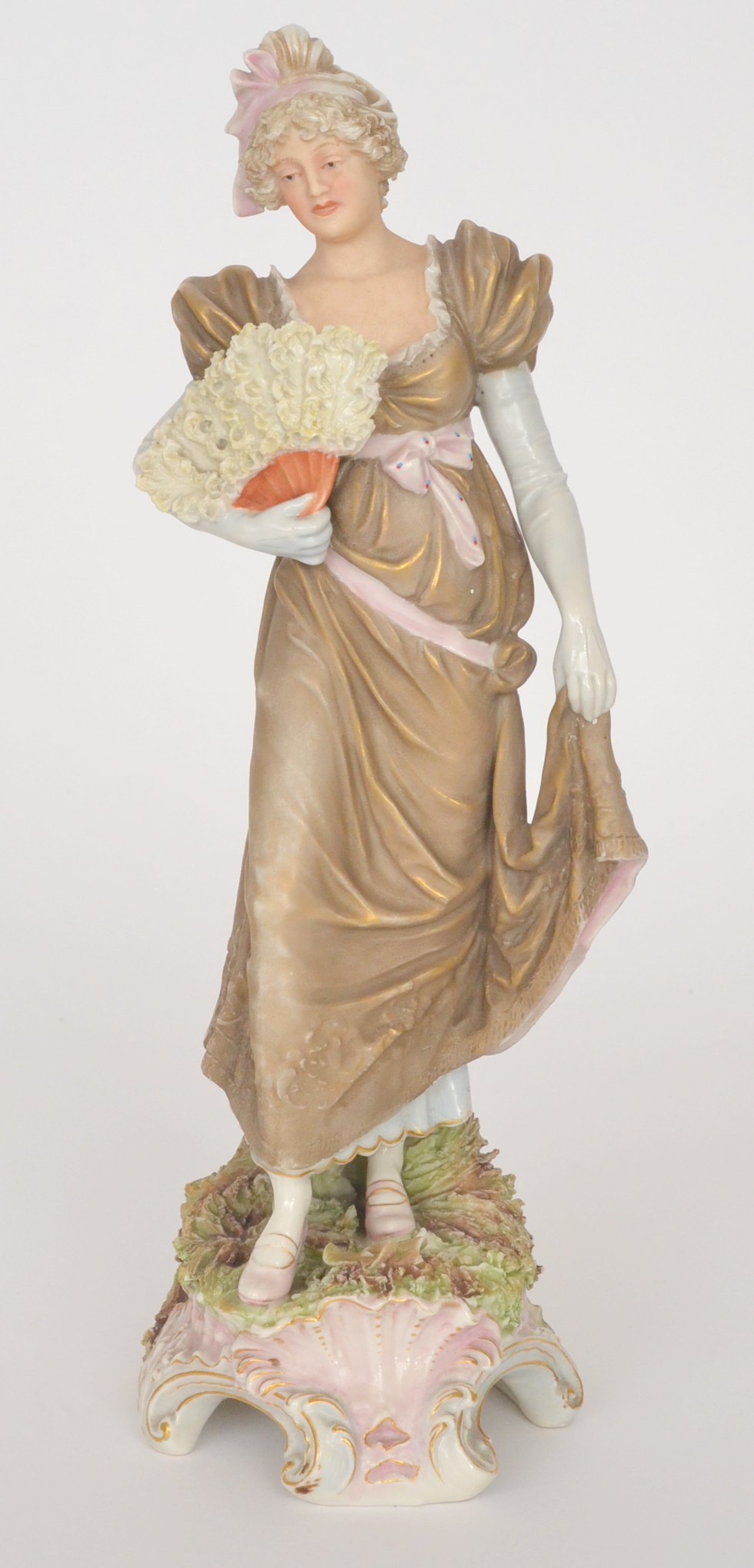 A 19th Century Continental figure of an Edwardian lady holding a feathered fan,