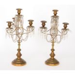 A pair of 20th Century gilt three branch table lustre's on circular bases,