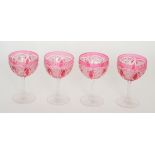 A set of four early 20th Century Stourbridge crystal drinking glasses with ovoid bowl cased in ruby