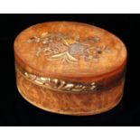 A late 19th Century tortoiseshell box of oval form with inlaid metal foliate detail to the lid and