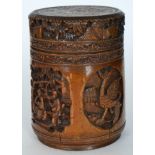 A late 19th and early 20th Century carved bamboo brush pot and cover decorated with panels of