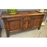 A 20th Century carved oak triple panel coffer chest, raised to stile feet, by G.T.