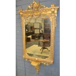 A 19th Century gilt mirror the rectangular plate surmounted with a pierced pediment above a garland