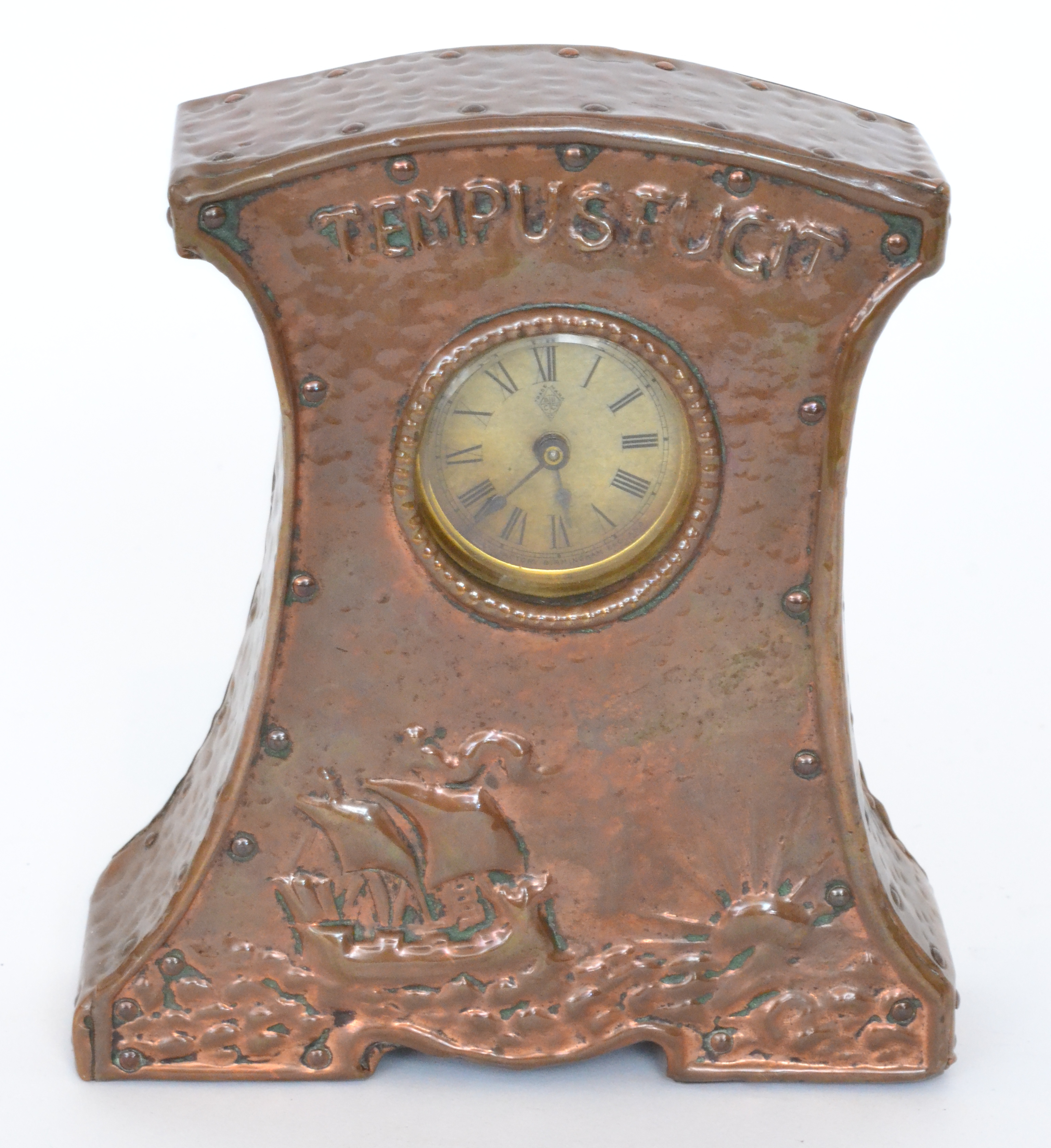 An early 20th Century 'Tempus Fugit' mantel clock in the Arts and Crafts style,