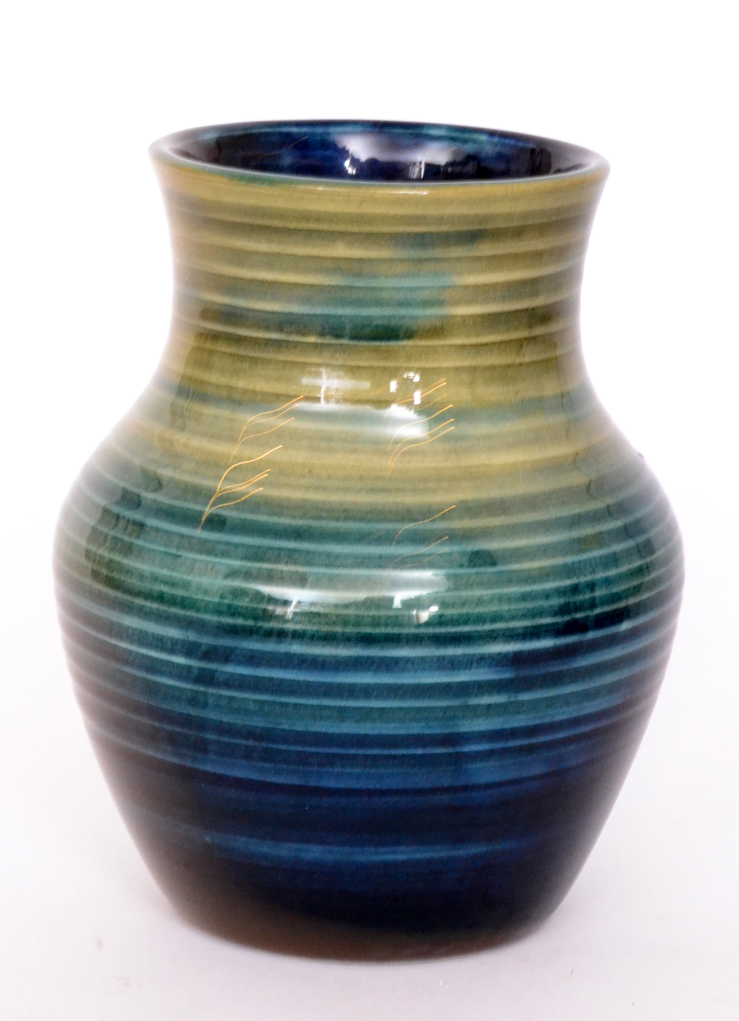 A Moorcroft 'Natural Pottery' vase of baluster form decorated in a tonal green glaze,