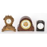 An Art Deco eight day strike arch topped mantle clock, together with two similar mantle clocks. S/D.