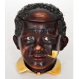 An early 20th Century Continental tobacco jar and cover modelled as the head of a young African boy