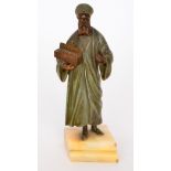 An early 20th Century cold painted bronze study of a standing Arab holding a jewellery box in the