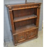 A small oak open bookcase with panelled cupboard base,