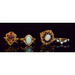 Four 9ct stone set rings to include a garnet, sapphire and opal and a single stone opal example.