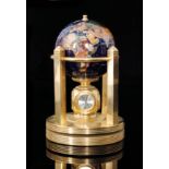 A blue lapis and polished stone 11cm desk globe with combination triple clock faces and thermometer