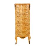 A 20th Century French style serpentine fronted light walnut chest of seven drawers,