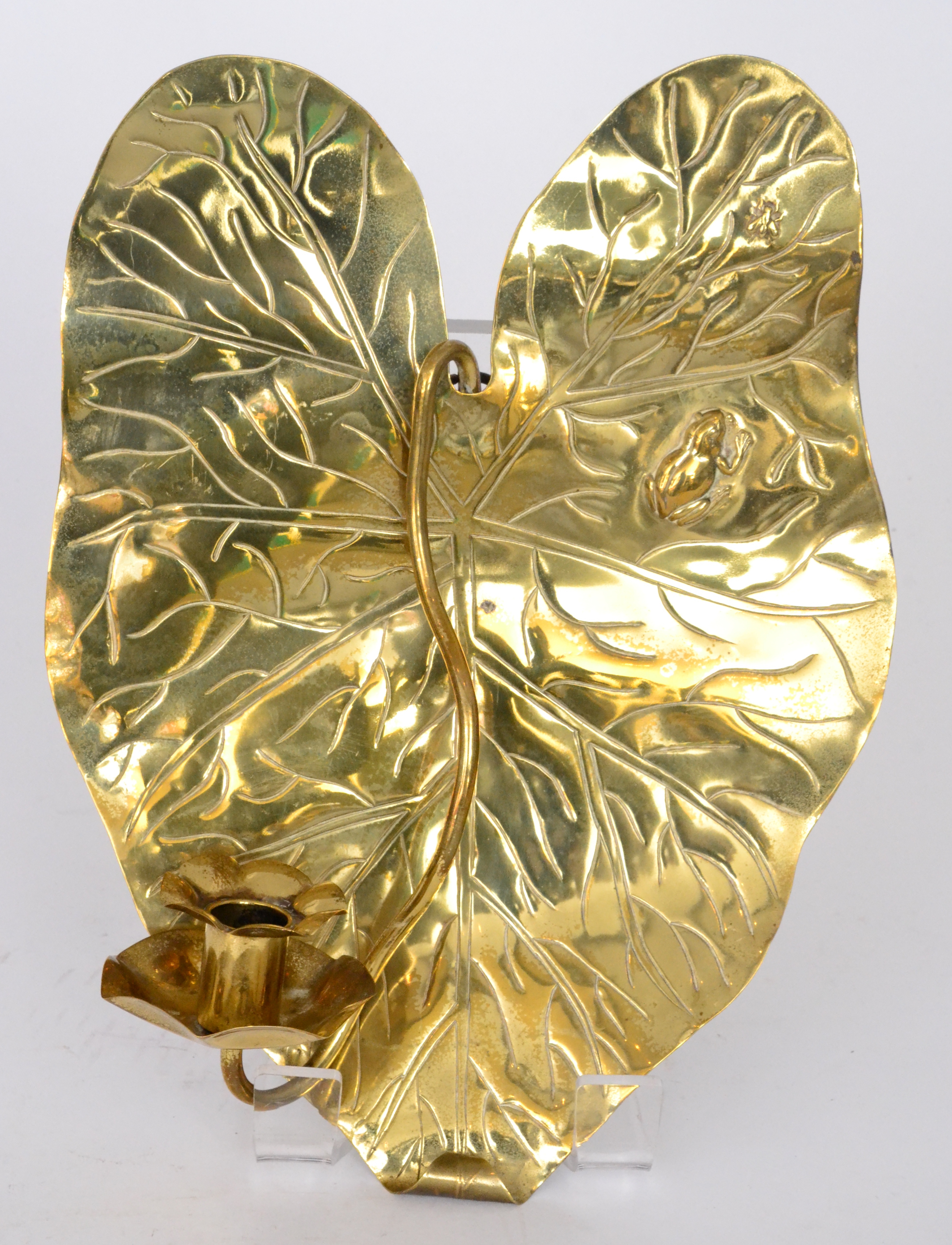 A brass wall sconce formed as a lily pad with a frog watching a fly, in the Arts and Crafts style,