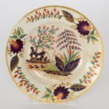 A late 18th Century Derby cabinet plate decorated with stylised flowers and foliage in enamel and