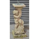 A 20th Century composite stone sundial modelled as a standing cherub,