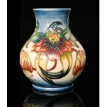 A Moorcroft Pottery vase of compressed baluster form decorated in the Anna Lily pattern designed by