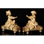 A pair of gilt garnitures or chenets modelled as children each with outstretched hands on a stepped