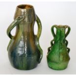 A late 19th Century pottery vase of skittle form decorated with two wrythen snake handles,