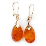 A pair of Russian 14ct gold and amber pendant earrings with graduated ovoid amber drops fitted to