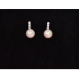 A pair of 9ct white gold cultured pearl and diamond drop earrings,