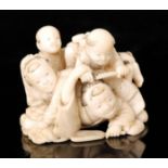 A late 19th Century Japanese carved ivory okimono group figure of five boys tumbling,