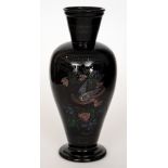 A late 19th Century black glass vase of footed shouldered ovoid form with flared collar neck,