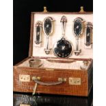 An early 20th Century crocodile skin travelling dressing case retailed by Stewart Dawson & Co Ltd,