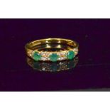 A modern hallmarked 18ct emerald and diamond half eternity ring,