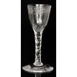 An 18th Century drinking glass circa 1785 with a round funnel bowl bright engraved to the upper rim