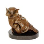 A contemporary sculpture in a bronzed finish of an owl and her young, bears signature A.