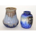 Two Ruskin Pottery vases, the first of globe and shaft form decorated in a streaked blue glaze,