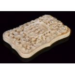 A late 19th Century Chinese carved ivory card case of cartouche rectangular form,