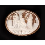 A later 20th Century oval cameo brooch carved with a classical scene of maidens seated beneath a