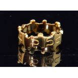 A Lucy Quartermaine sterling silver and gold overlay ring of interlinked jigsaw puzzle pieces