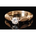 A 9ct hallmarked diamond solitaire ring, brilliant cut claw set stone to shaped shoulders,