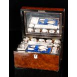 A Victorian burr walnut dressing case the mirrored interior above a trap compartment inset with