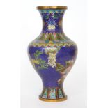 An early 20th Century cloisonne baluster shaped vase decorated with flowers on a blue ground