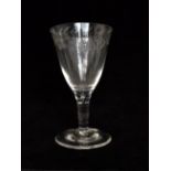 A late Georgian drinking glass with a large round funnel bowl engraved to the upper border with a