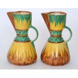A pair of 1930s Art Deco Wadeheath shape 90 jugs each decorated in pattern 3623 with green,