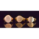 Three 9ct gentleman's signet rings, two plain and one set with a single stone to centre,