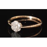 An early 20th Century 18ct diamond daisy cluster ring comprising of seven old cut stones to knife