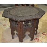 A 19th Century carved hardwood octagonal occasional table on folding stand together with a