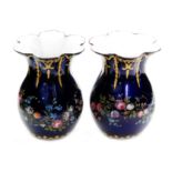 A pair of 19th Century miniature enamelled vases of baluster form with flared petal rims,