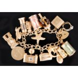 A 9ct hallmarked open curb link charm bracelet with various charms attached,