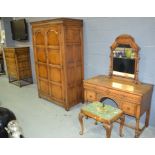 A carved oak bedroom suite by Thomas Clarkson Wolverhampton, comprising a double door wardrobe,