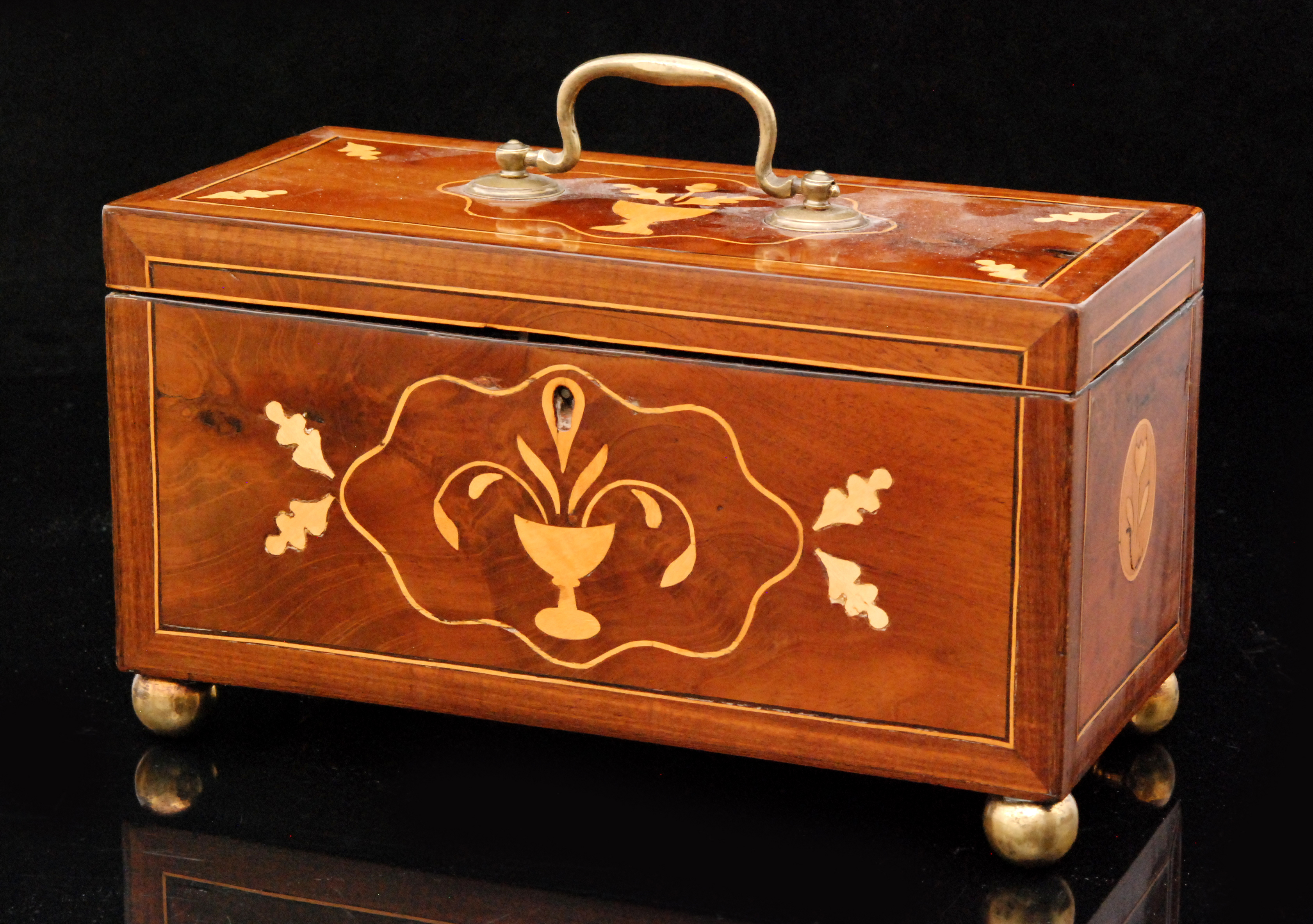 A 19th Century inlaid mahogany tea caddy decorated with primitive flowers centred with vases on