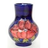 A Moorcroft vase of globe and shaft form decorated in the Anemone pattern with tubelined flowers