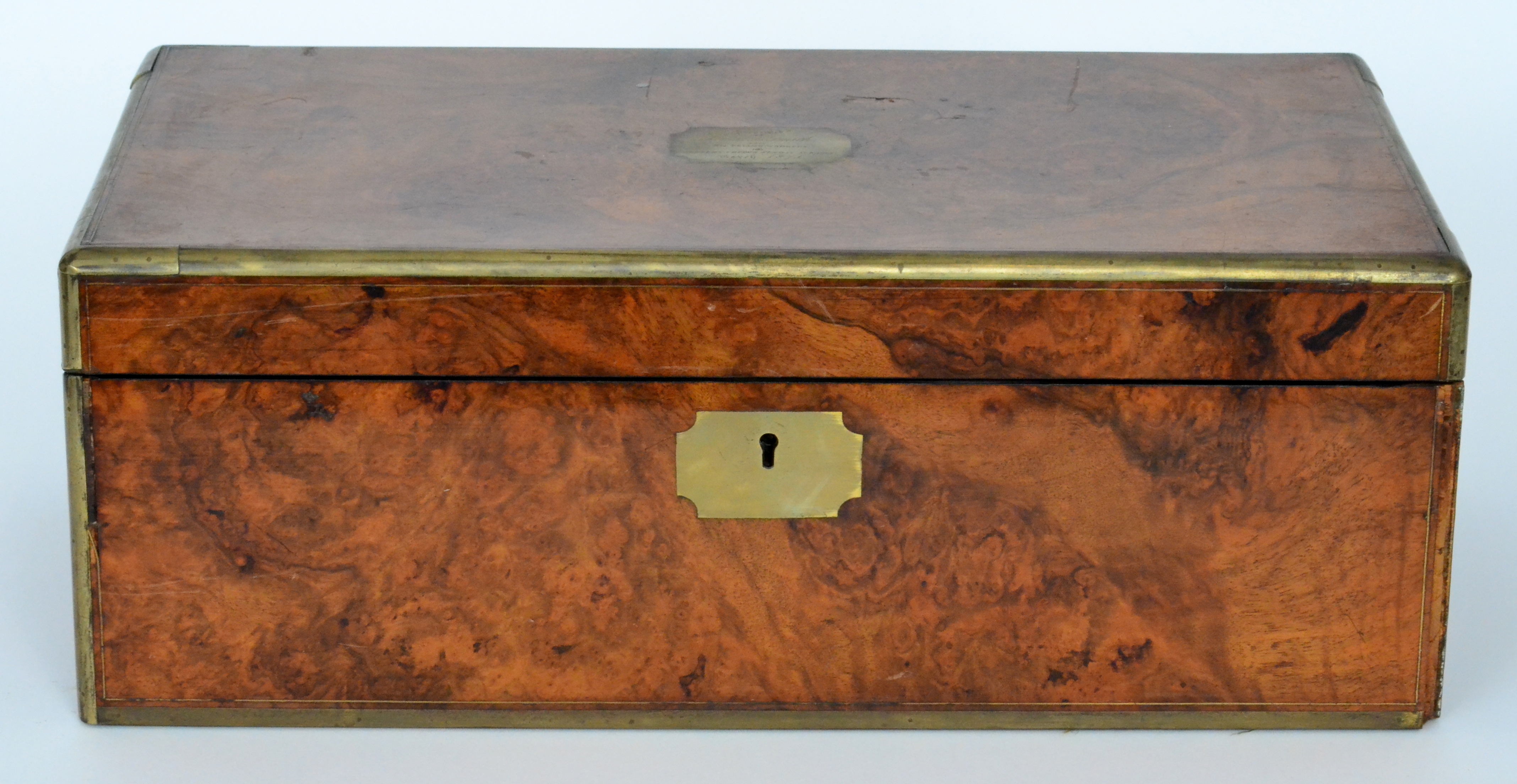 A 19th Century brass banded figured walnut writing box with fitted interior inset with inscription