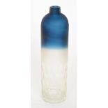 A contemporary bottle vase of cylindrical form with narrow collar neck in a graduated deep blue to