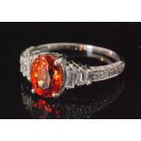 An 18ct white gold orange sapphire and diamond ring,